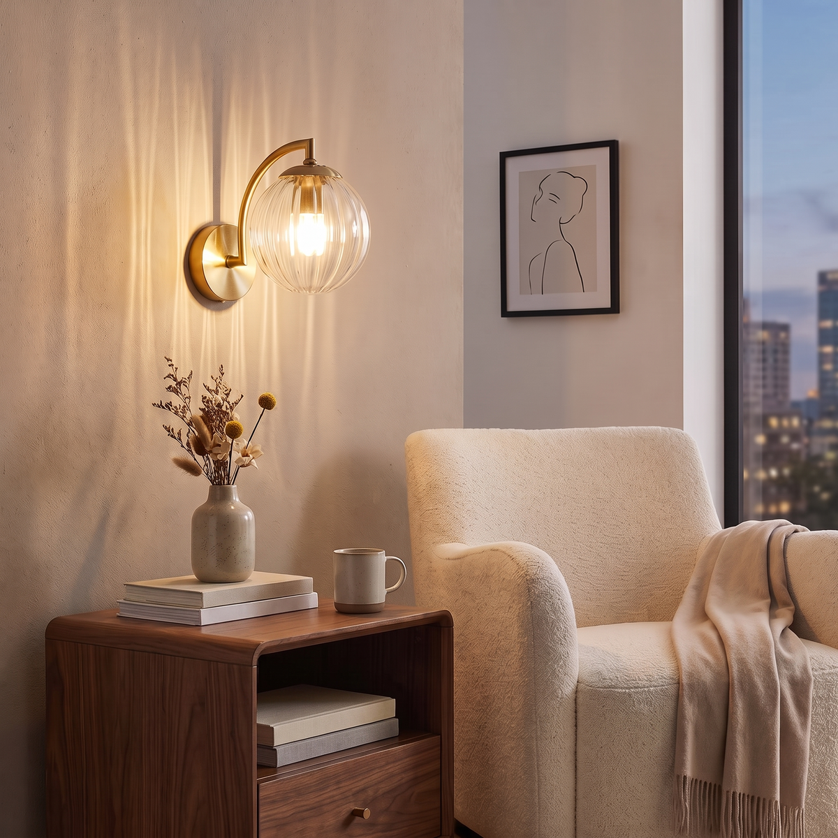 Curved Arm Ball Sconce in brass with ribbed glass globe, lit above a walnut nightstand