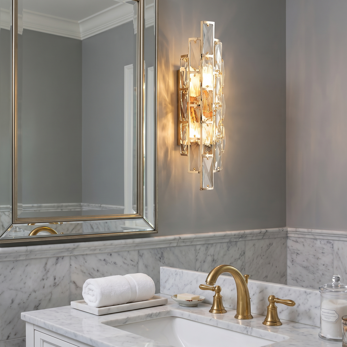 Crystal wall sconce beside powder room mirror