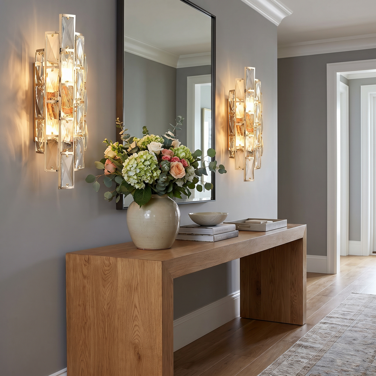 Pair of crystal wall sconces flanking entry hall mirror