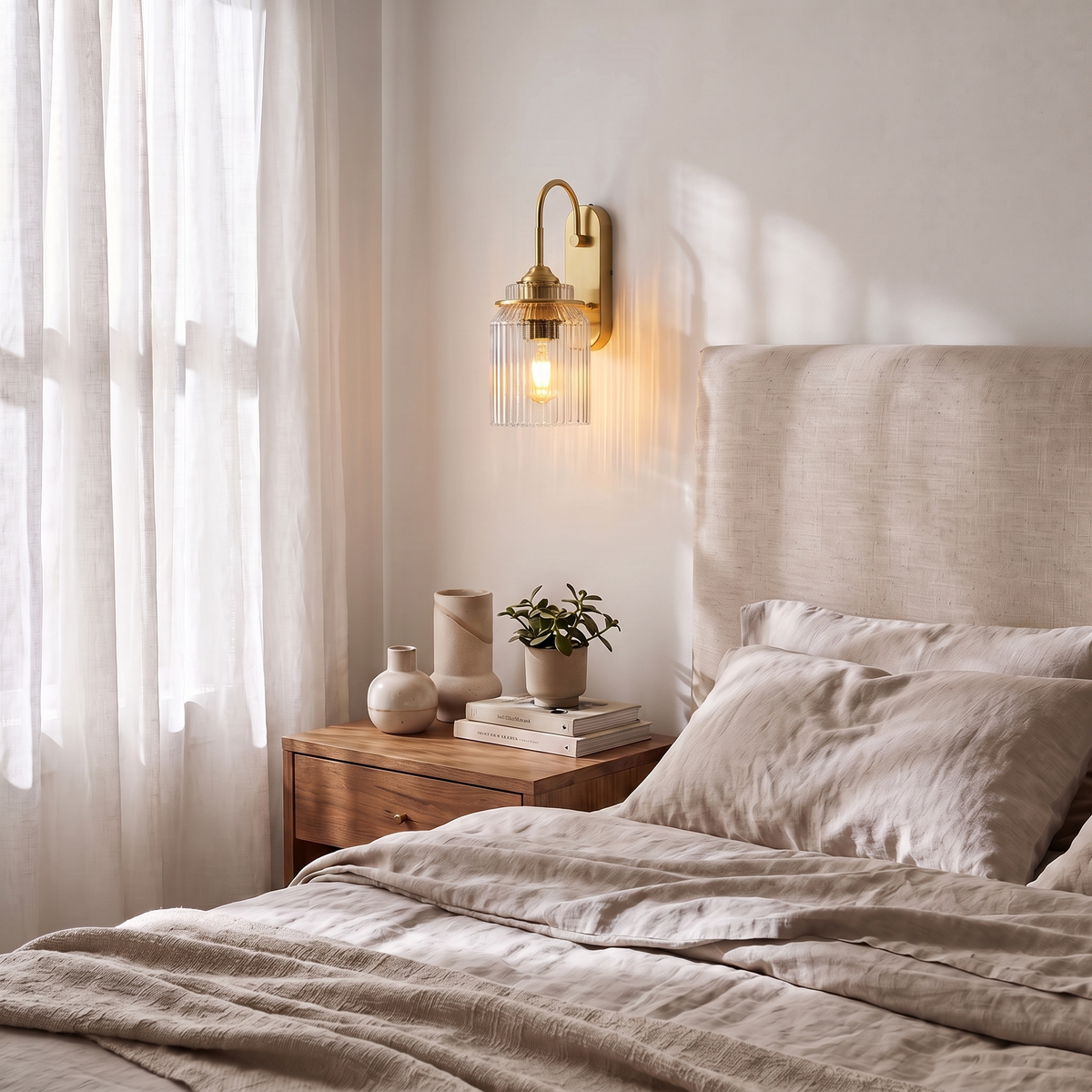 Gold wavy glass wall sconce above bedroom nightstand
