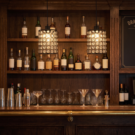 Crystal Cylinder Pendant Lights above a home bar