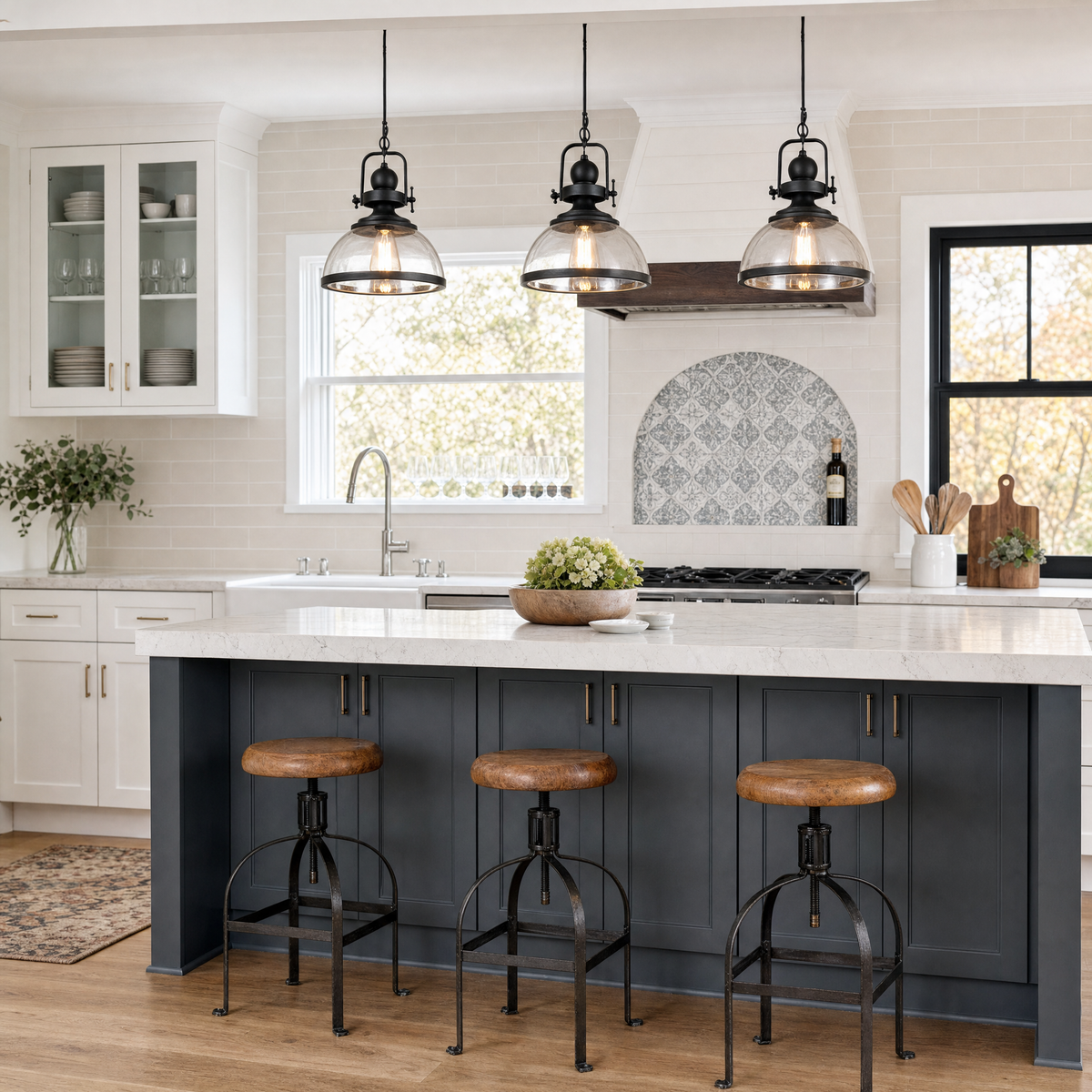 Clear Glass Bowl Pendant Lights above a white and black kitchen island
