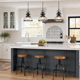 Clear Glass Bowl Pendant Lights above a white and black kitchen island