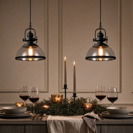 Clear Glass Bowl Pendant Lights over a candlelit dining table