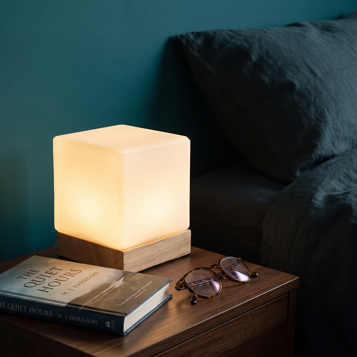 Square Wood Cube Lamp on a bedside table against a teal wall