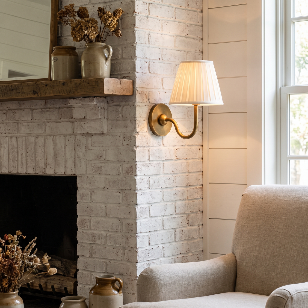 Luvora Fabric Drum Wall Sconce beside a living room fireplace