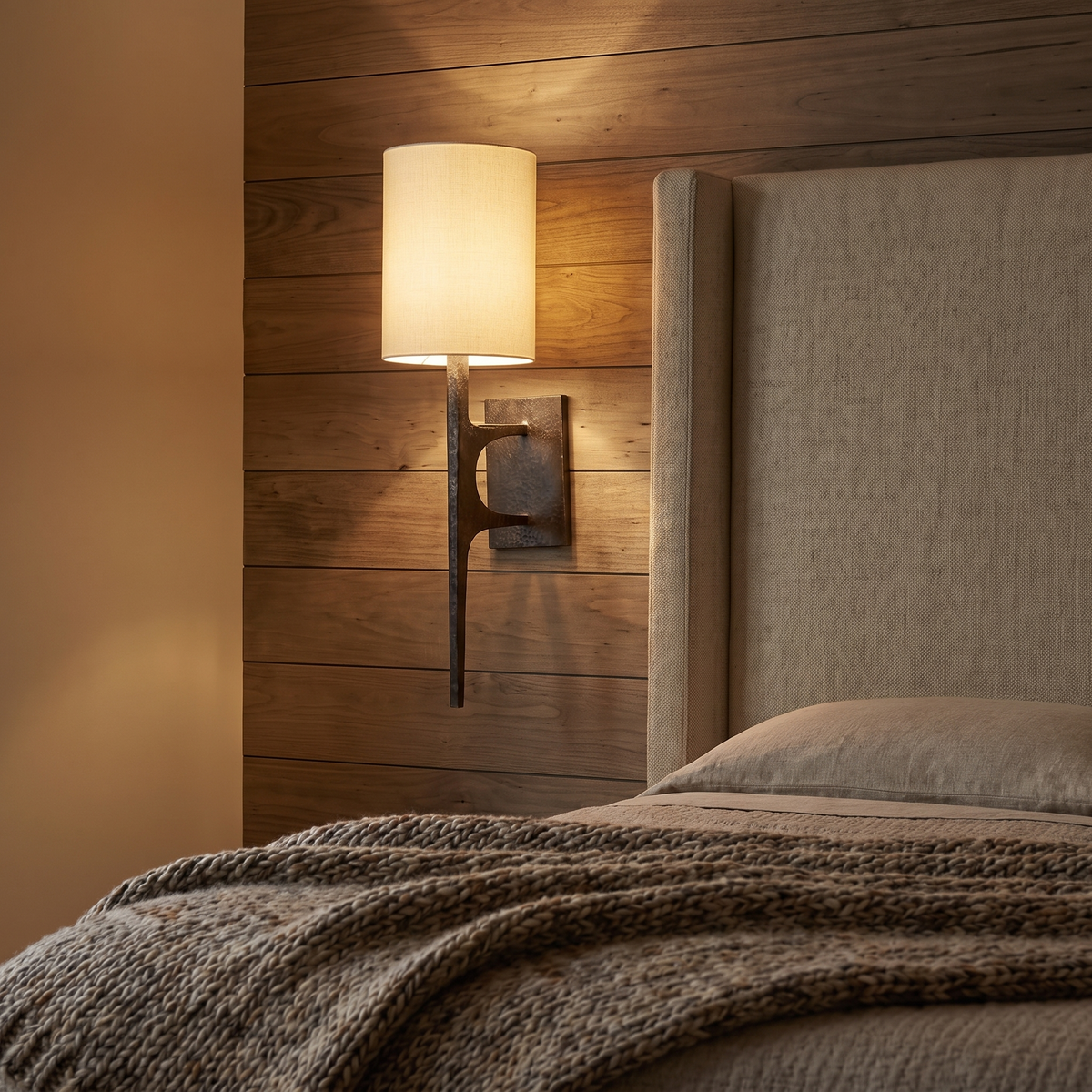 Mavora Hammered Metal Wall Light beside a bedroom headboard