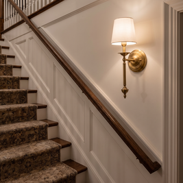 Rowan Antique Copper Wall Sconce on a staircase wall