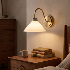 Aurenza Curved Arm Globe Sconce above a bedroom nightstand