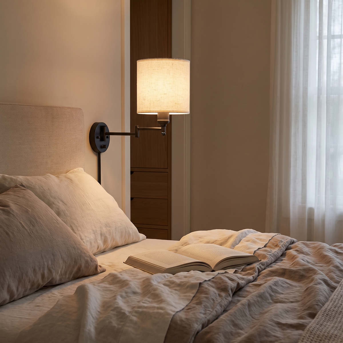 Swing Arm Fabric Sconce Light beside a bedroom headboard
