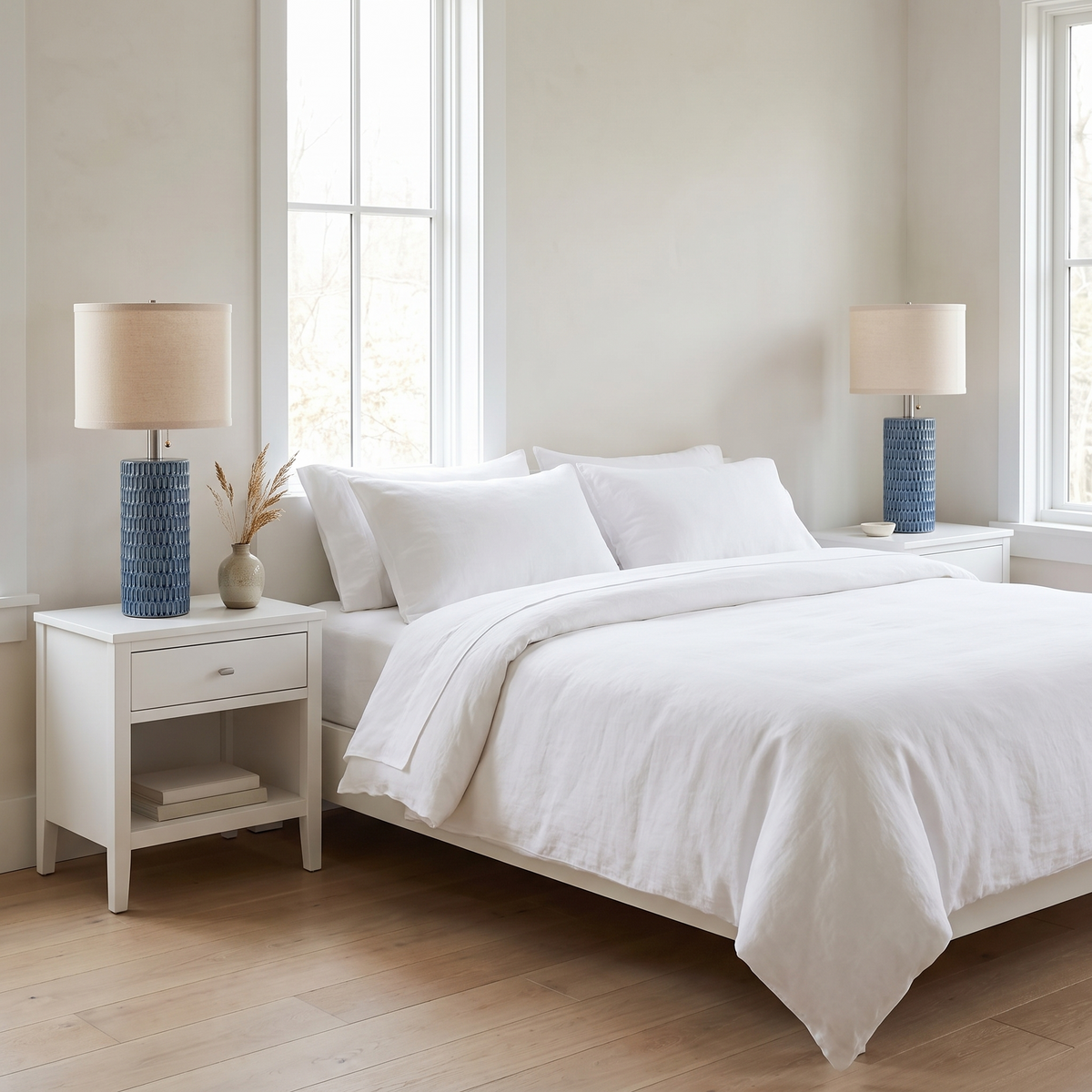 Blue ceramic lamps on nightstands in a coastal minimalism bedroom