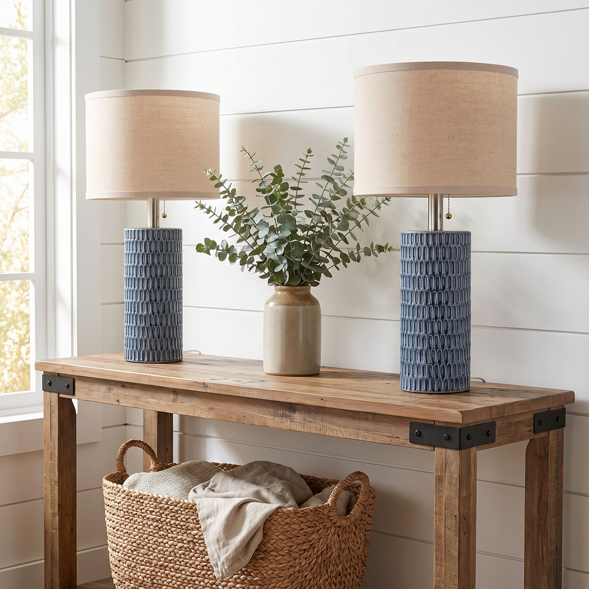 Blue ceramic lamp pair in a modern farmhouse setting with shiplap and reclaimed wood