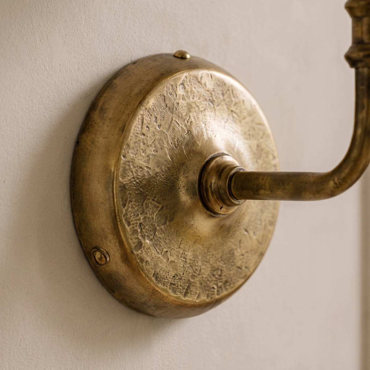Close-up detail of the Roven sconce wall plate and mounting connection