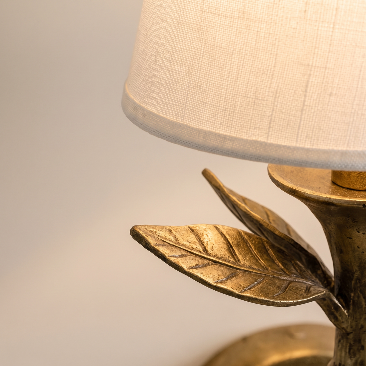 Close-up detail of the Roven sconce lampshade and surrounding leaves