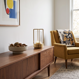 Crystal Table Lantern in natural brass on a walnut credenza in a mid-century modern living room