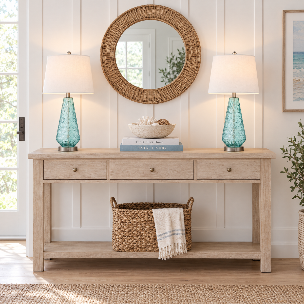 Pair of blue glass table lamps on a whitewashed console table in a modern coastal entryway